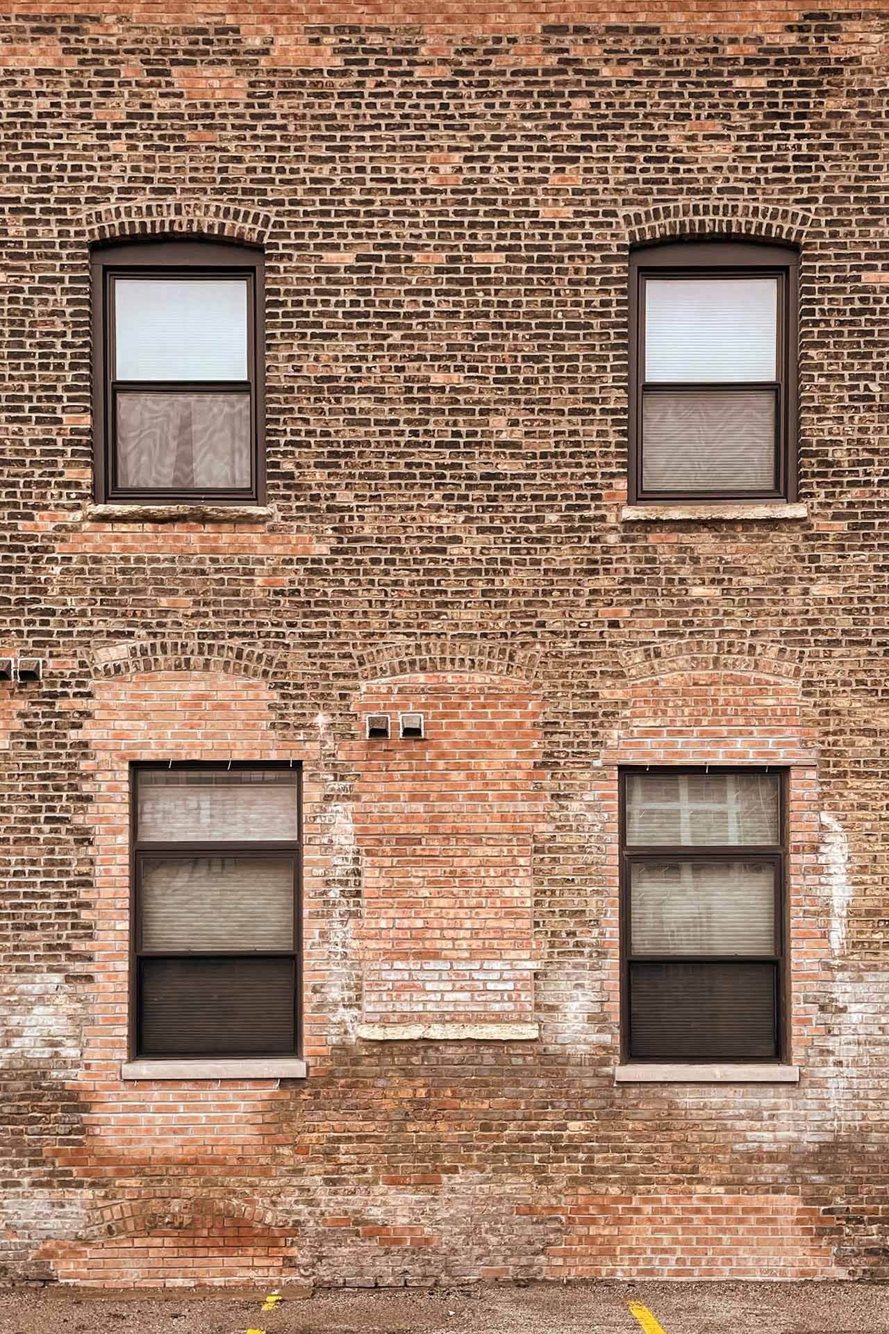 Four windows in a brick wall