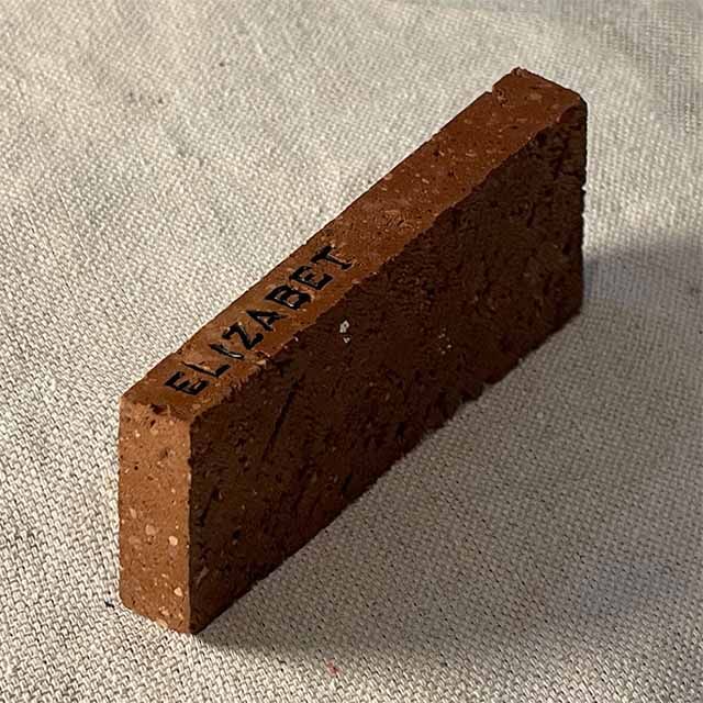 A brick material sample with the name 'Elizabet' engraved in it